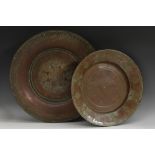 A Middle Eastern copper circular charger, chased in the Islamic taste with geometric motfs,