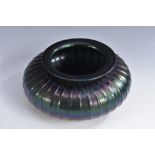 An Art Nouveau iridescent glass fluted compressed ovoid vase, in the manner of Loetz, everted rim,