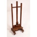 A 19th century oak mechanical artist studio easel, the ledge adjustable on a pulley,