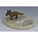 An early 20th century Austrian cold painted bronze, of a fox, he stands, holding captured fowl,