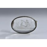A 19th century rock crystal oval intaglio, cut in the Classical taste and mounted as a brooch,