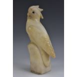 A 19th century carved alabaster model of a cockatoo, glass eyes, 21.