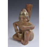 A South American museum copy of a Pre-Columbian figural vessel, picked out in earth tones,