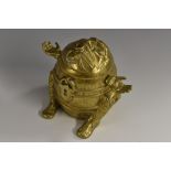 A 19th century brass novelty string box, as a comical figure trapped within a barrel,