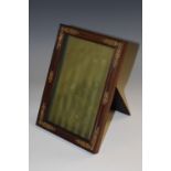 A late 19th century French gilt-metal mounted rosewood rectangular easel photograph frame,