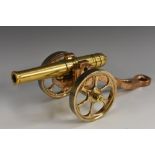 An early 20th century polished bronze desk model signal canon, 19cm barrel with touch hole,