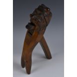 A Black Forest lever-action novelty nutcracker, carved as a grimacing gentleman wearing a cloth cap,