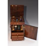 A George III mahogany apothecary cabinet, hinged cover above a door,