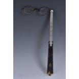 A 19th century tortoiseshell lorgnette, long haft with ring terminal,