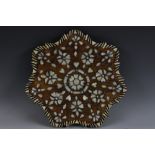 A late 19th century Ottoman hardwood and mother-of-pearl shaped circular table-top plateau,
