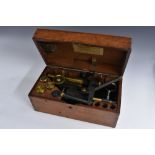 A late 19th/early 20th century brass and patinated brass microscope, rack and pinion adjustment,