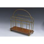 An Edwardian oak and brass periodical rack, arched handle, stepped rectangular base,