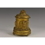 A 19th century ormolu inkwell, cast in relief with eagles, hinged cover with fluted knop finial,