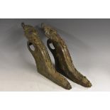 A pair of French dark patinated bronze curtain pole brackets,