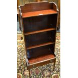 A reproduction bookcase, with shaped back, open shelves, drawer to base,