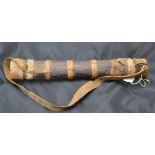 A 19th century tribal bark and hide quiver containing bone and iron tipped grass arrows