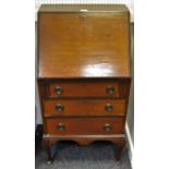 A mahogany bureau of small proportions, fall front including pigeon holes over three drawers,