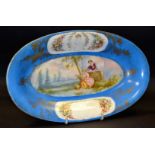 A French Serves oval dish, painted with courting couple, within a blue celeste ground, c.