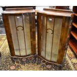 A pair of 1940's walnut display cabinets, serpentine front, single glazed door, cabriole legs,