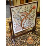 A silkwork mahogany fire screen/table