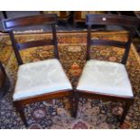 Two George III mahogany chairs, curved top rail, horizontal splat, drop in seat, sabre forelegs,