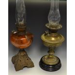 A late Victorian oil lamp, tangerine glass reservoir,
