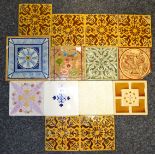 A set of six early 20th century tiles, in tan on a mustard ground; other tiles,