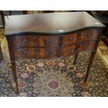 A reproduction Regency serpentine fronted sideboard, crossbanded top, four cockbeaded short drawers,