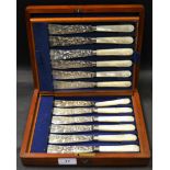 An oak case containing twelve mother of pearl hafted fish knifes by William Hutton & Sons,