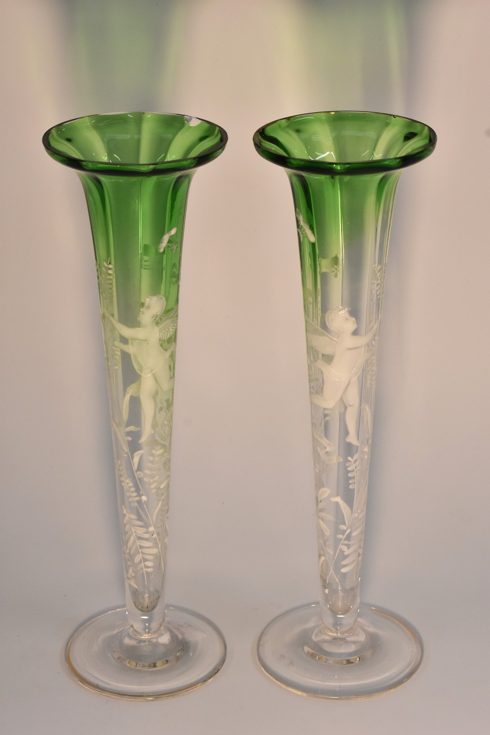 A pair of Mary Gregory green flashed trumpet shaped specimen vases,