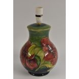 A Moorcroft Hibiscus pattern baluster shaped table lamp, tube lined with large flowerheads in red,
