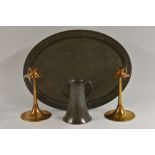 A pair of Arts and Crafts brass candlesticks, with large drip pans, spreading circular bases, 20.