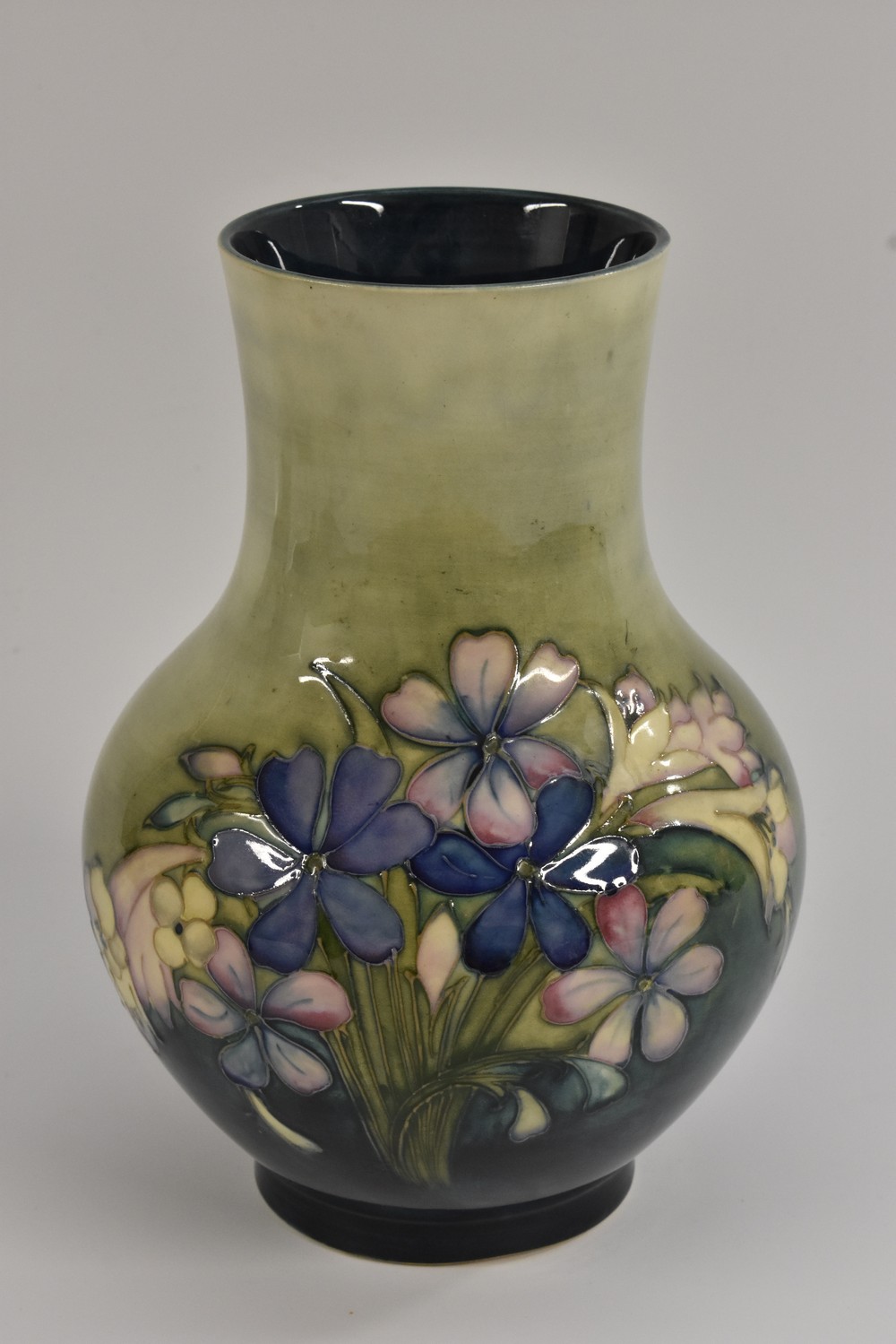 A Moorcroft Spring Flowers baluster vase, tube lined with flowers and foliage in blue and pink,