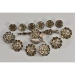 A set of six silver coloured metal two part buttons,