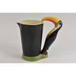 A Carlton ware Guinness advertising toucan jug, moulded as a toucan standing beside a black jug,