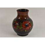 A Moorcroft Poppy pattern vase, tube lined with large flowers and foliage, on a flambe ground,