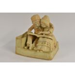 An Amphora figure group, of two Dutch children seated reading a book, in blush ivory,