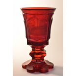A 19th century Bohemian ruby glass, engraved panels each with a building, inscribed Steinbad,