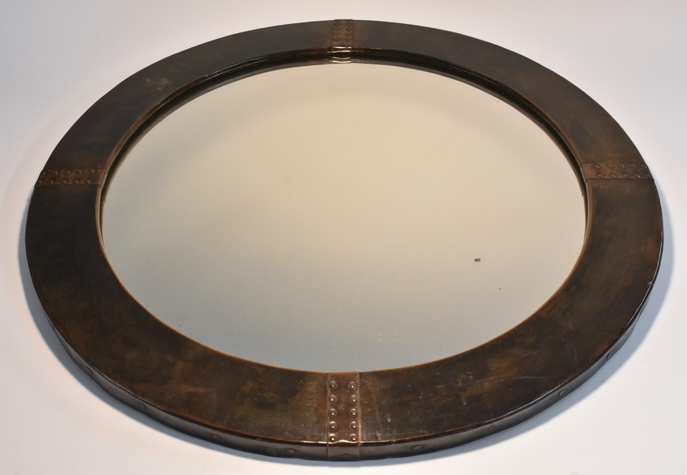 A Liberty London dark patinated bronze circular wall mirror,