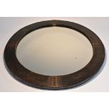 A Liberty London dark patinated bronze circular wall mirror,