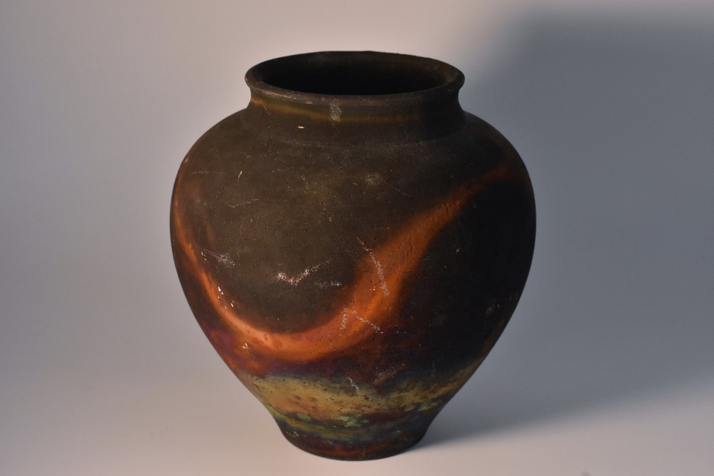 A Raku shouldered ovoid vase in the manner of Pat Armstrong, mottled tones of green, blue,