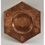 An Arts and Crafts copper hexagonal charger, by Art Fittings Ltd, London,