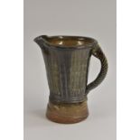 Studio Pottery - a Jane Hamlyn salt glazed jug, impressed with reeded bands, rope twist handle,