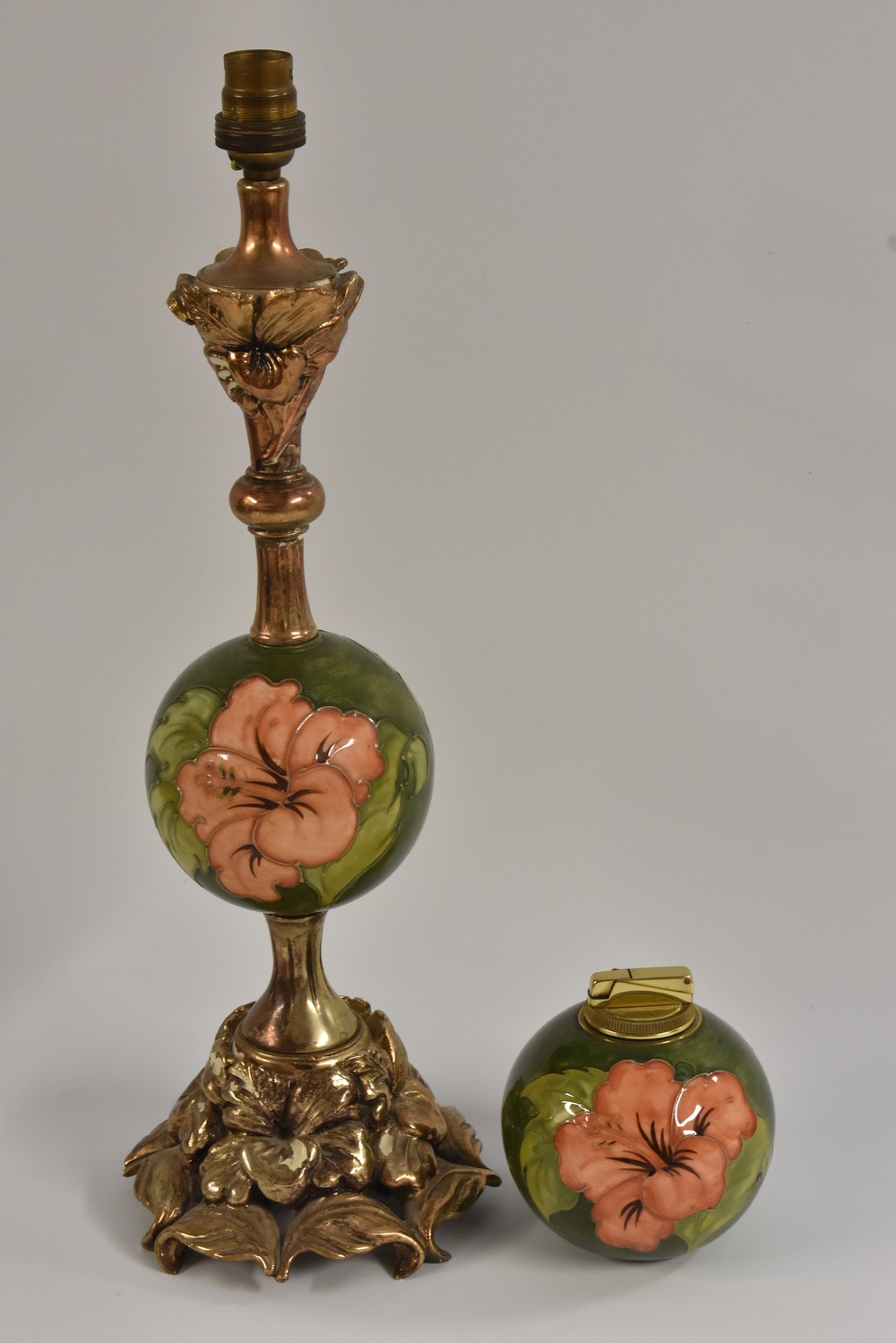 A Moorcroft and gilt metal mounted Hibiscus pattern table lamp, cast with flowers,