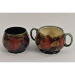 A Moorcroft Pomegranate pattern two handled sugar bowl, tube lined with whole fruit and berries,