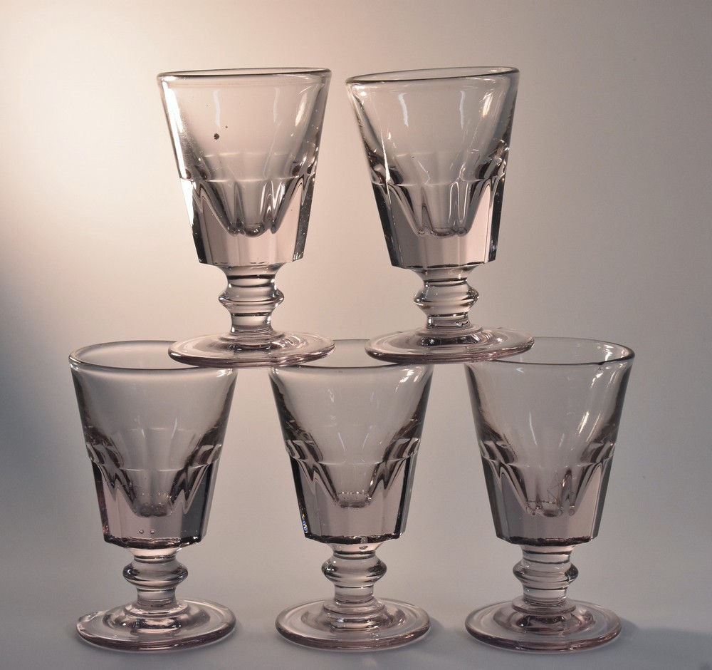 A set of five 19th century amethyst tinted glass rummers, bucket shaped half facetted bowls,