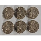 An Art Nouveau set of six silver lady's dress buttons,
