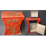 A Japanese red lacquered lyre shaped bedside cabinet, floral and bird decoration,