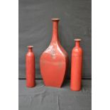 A set of three ceramic floor standing vases, drip glazed in sang-de-boeuf tones, the largest 77.