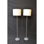 A pair of modern standard lamps